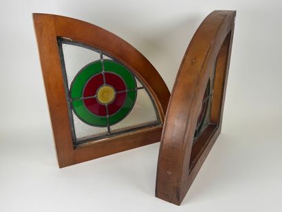 Two rounded triangular stained glass windows,...