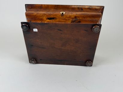 Wood and veneer chest in the shape of a sarcophagus.
Restoration...