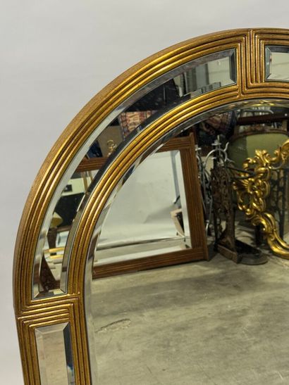 Gilded wood mirror with rounded top and beveled...