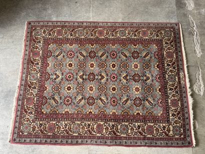 Polychrome wool carpet with floral motifs....