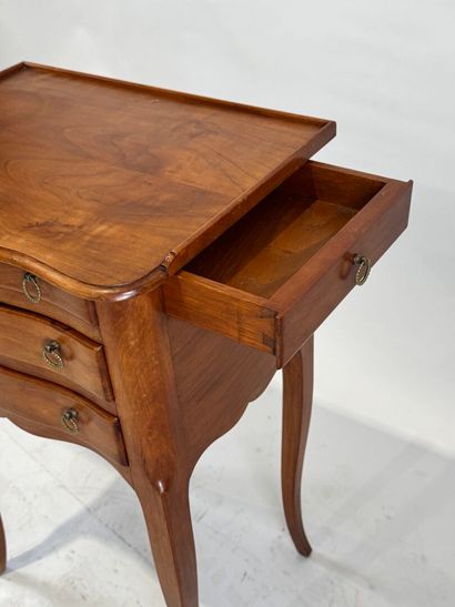 Moulded wood bedside table opening with three...