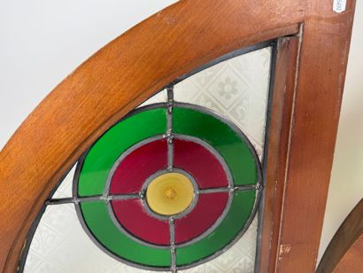 Two rounded triangular stained glass windows,...