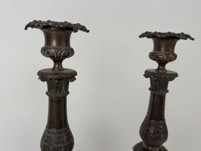 Pair of tripod candlesticks in patinated...