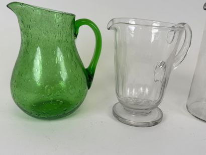 Three glass pitchers, one bubbled colored...