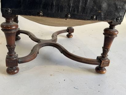 Small low chair in molded wood, black leather...