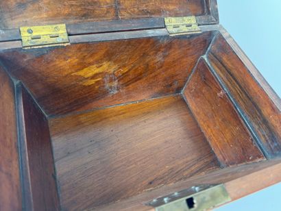 Wood and veneer chest in the shape of a sarcophagus.
Restoration...