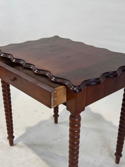 Small stained wood table or desk opening...