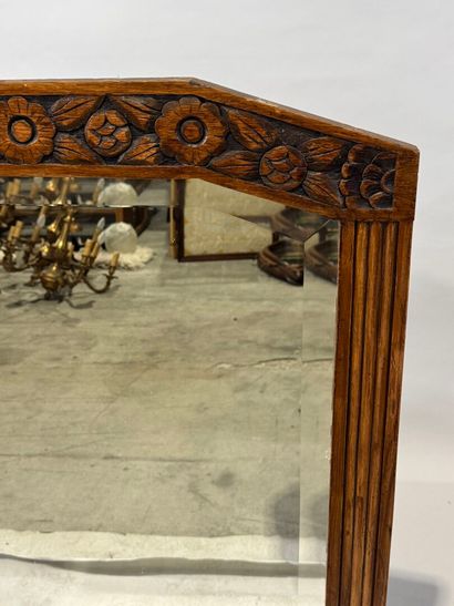 Molded and carved wood mirror with a frieze...