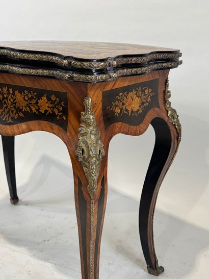 Wood and marquetry game table featuring a...