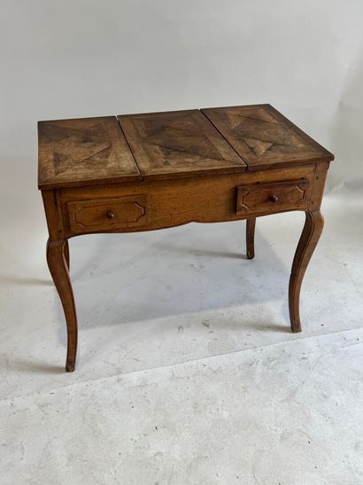 Moulded walnut dressing table, the top opening...