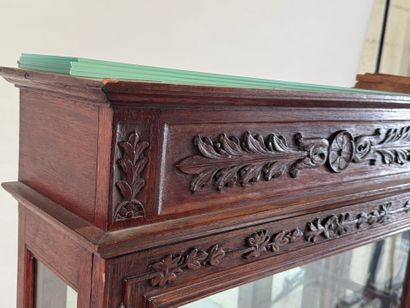 Moulded, carved and stained oak display case...