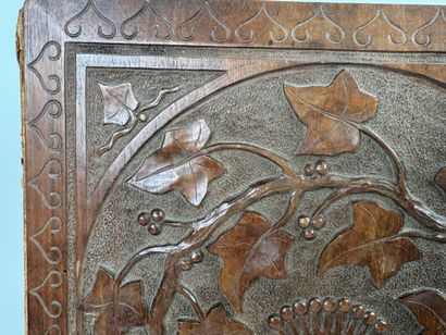 A two-plate folio in carved wood with the...