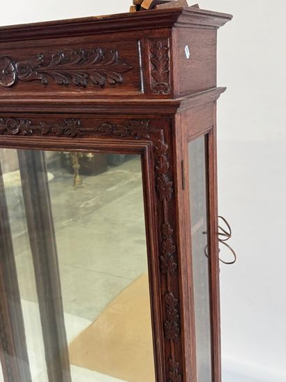Moulded, carved and stained oak display case...