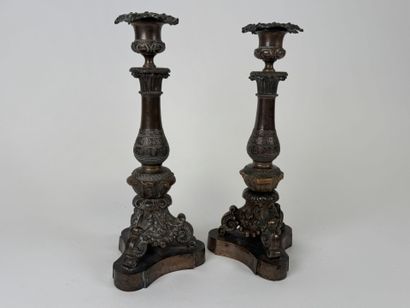 Pair of tripod candlesticks in patinated...
