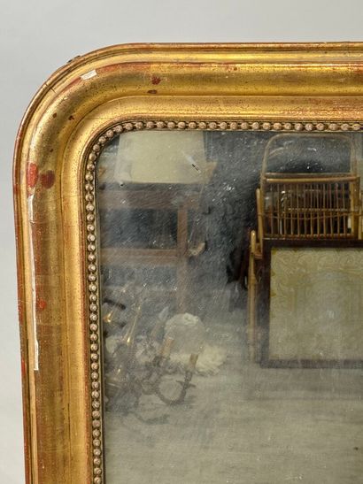 Wood and gilded stucco mirror decorated with...