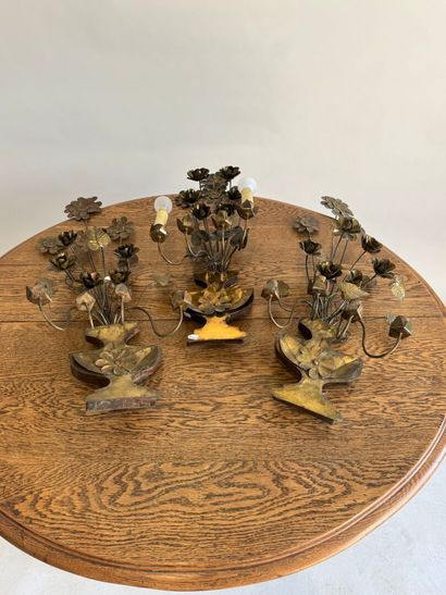 Suite of three four-light gilded metal sconces...