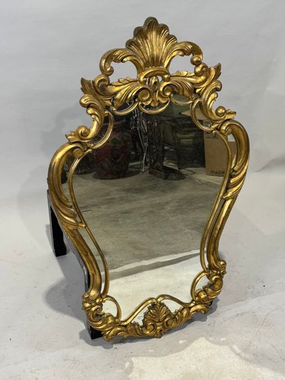 Gilded wood glazed mirror with a violin shape,...