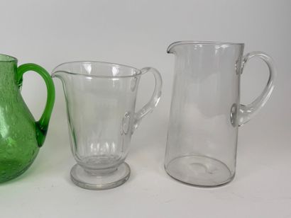 Three glass pitchers, one bubbled colored...