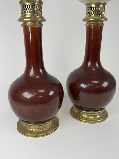 Pair of glazed ceramic kerosene lamps on...
