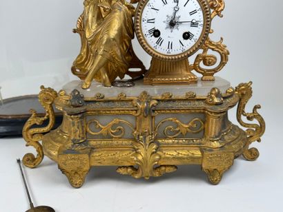 Gilded regule and alabaster clock decorated...