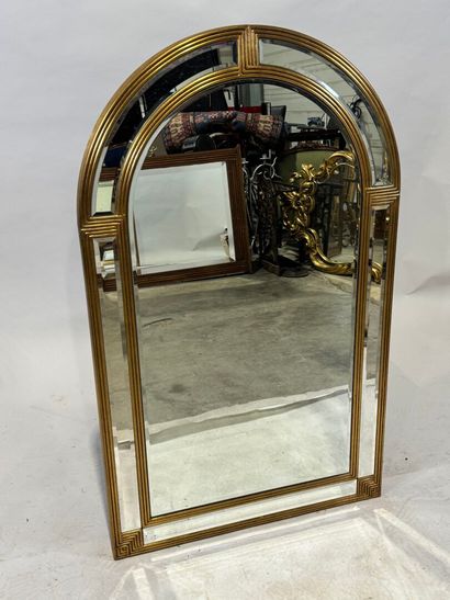 Gilded wood mirror with rounded top and beveled...