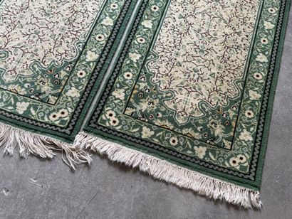 IRAN. 
Suite of three polychrome wool carpets...