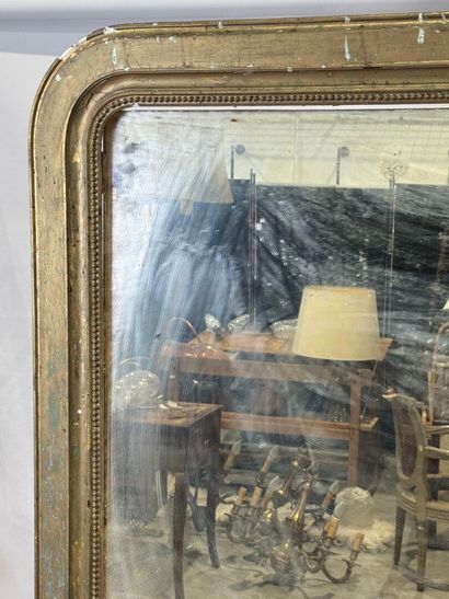 Large mirror in wood and gilded stucco decorated...
