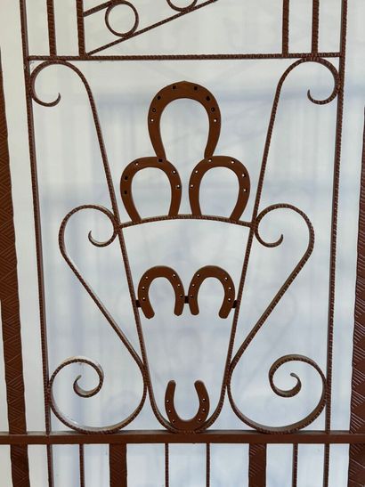 Wrought and painted iron checkroom decorated...