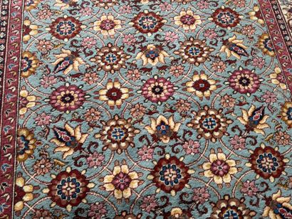 Polychrome wool carpet with floral motifs....