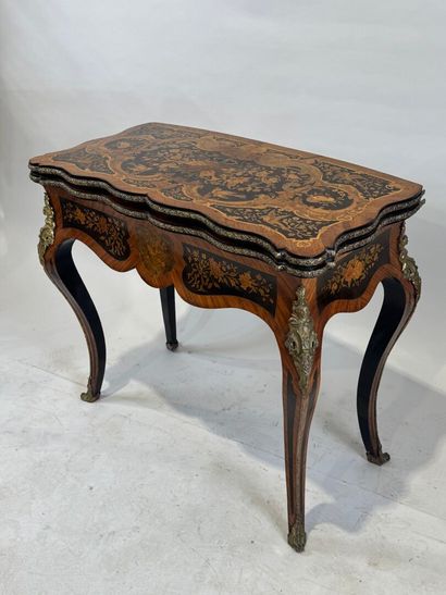 Wood and marquetry game table featuring a...