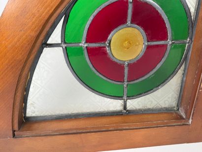 Two rounded triangular stained glass windows,...