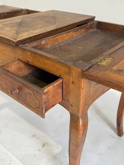 Moulded walnut dressing table, the top opening...