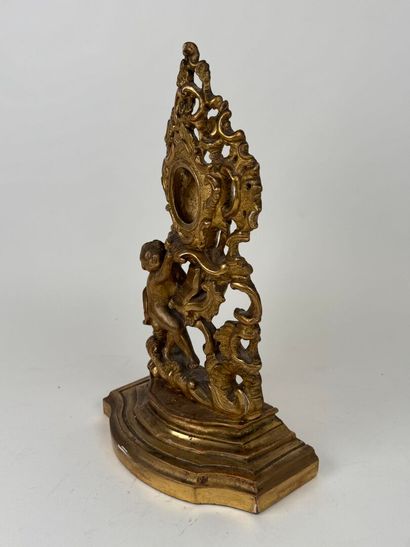 Carved and gilded wood and stucco watch-holder...