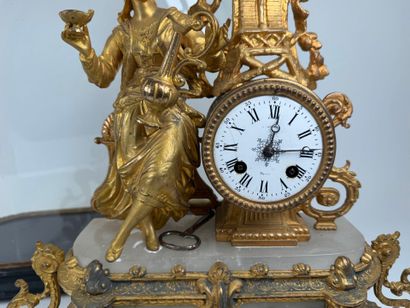 Gilded regule and alabaster clock decorated...