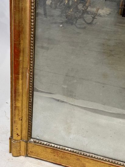 Wood and gilded stucco mirror decorated with...