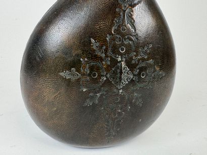 Leather-wrapped flask with small iron motif.
H....