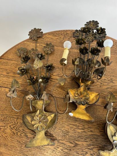 Suite of three four-light gilded metal sconces...
