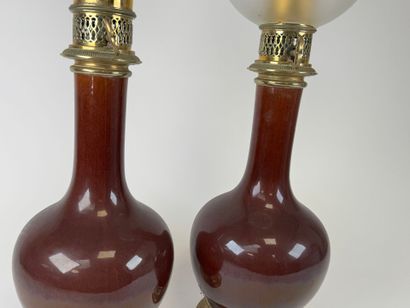 Pair of glazed ceramic kerosene lamps on...