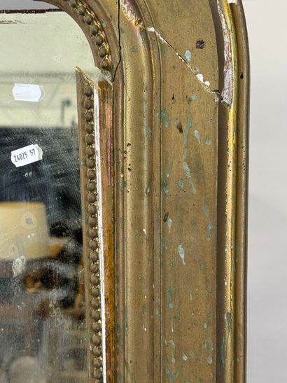 Large mirror in wood and gilded stucco decorated...