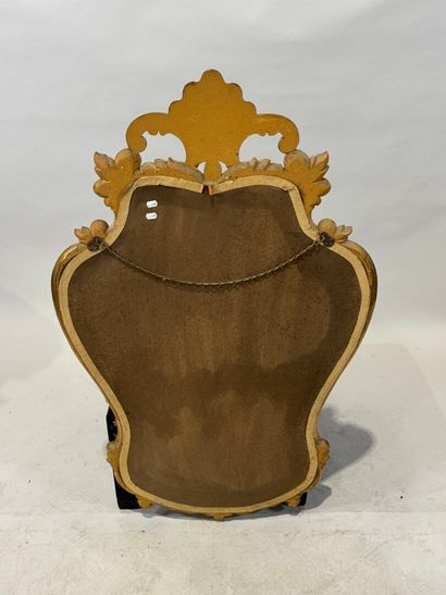 Gilded wood glazed mirror with a violin shape,...