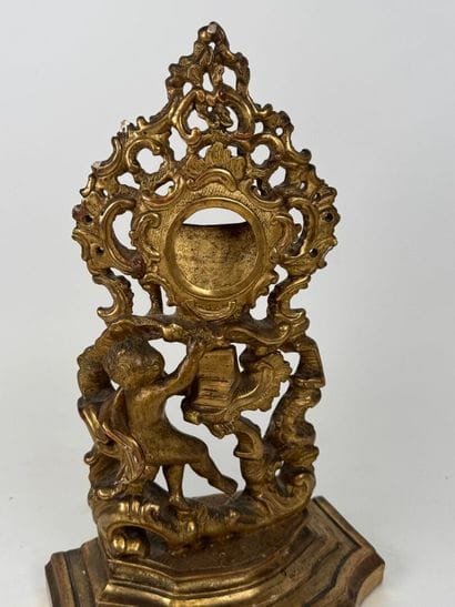 Carved and gilded wood and stucco watch-holder...