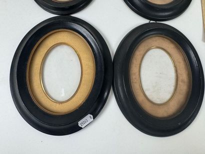 Set of four blackened wood and glass picture...