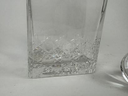 Cut crystal decanter. H. 20.5 cm. An identical...