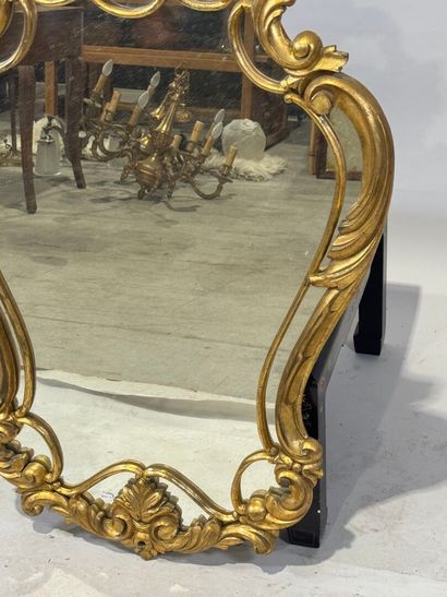 Gilded wood glazed mirror with a violin shape,...