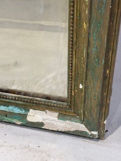 Large mirror in wood and gilded stucco decorated...