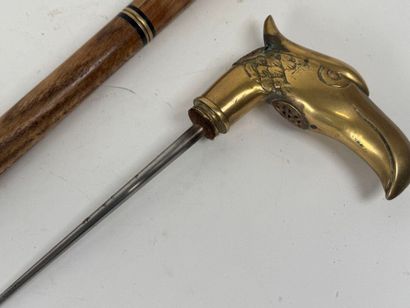 Wooden and brass system cane, the pommel...