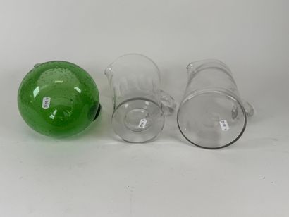 Three glass pitchers, one bubbled colored...