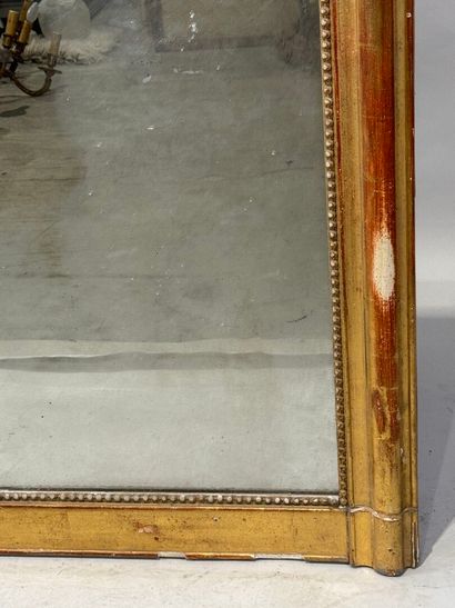 Wood and gilded stucco mirror decorated with...