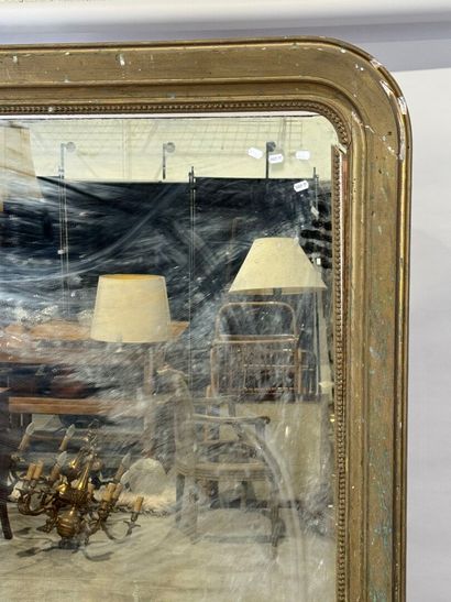 Large mirror in wood and gilded stucco decorated...