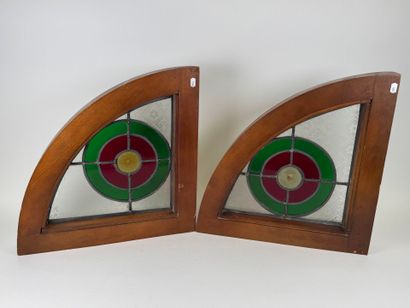 Two rounded triangular stained glass windows,...